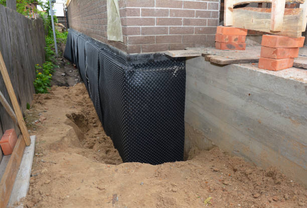 Happy homeowners after waterproofing job in De Pere